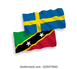 National vector fabric wave flags of Sweden and Federation of Saint Christopher and Nevis isolated on white background. 1 to 2 proportion.