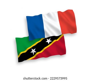 National vector fabric wave flags of France and Federation of Saint Christopher and Nevis isolated on white background. 1 to 2 proportion.