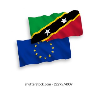 National vector fabric wave flags of European Union and Federation of Saint Christopher and Nevis isolated on white background. 1 to 2 proportion.