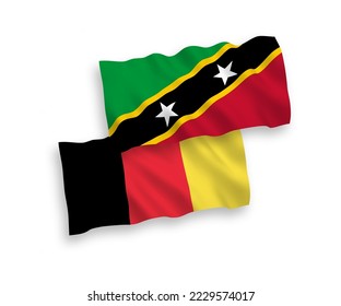 Nationale Vektor-Wellen-Flaggen der Föderation von Saint Christopher und Nevis und Belgien einzeln auf weißem Hintergrund. 1 bis 2 %.