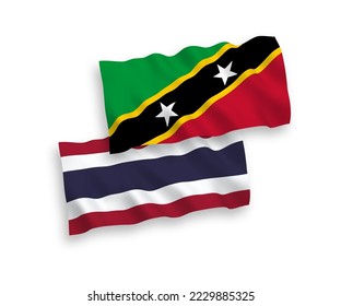Nationale Vektor-Wellen-Flaggen der Föderation von Saint Christopher und Nevis und Thailand einzeln auf weißem Hintergrund. 1 bis 2 %.
