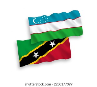 National vector fabric wave flags of Federation of Saint Christopher and Nevis and Uzbekistan isolated on white background. 1 to 2 proportion.