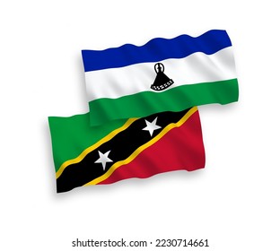 Banderas de ondulación de tela vectorial nacional de la Federación de Saint Christopher y Nevis y Lesotho aisladas de fondo blanco. de 1 a 2.