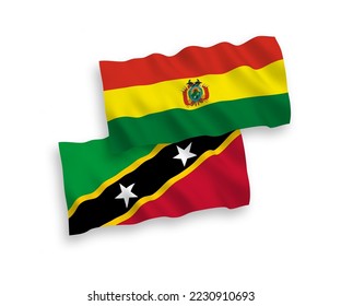 National vector fabric wave flags of Federation of Saint Christopher and Nevis and Bolivia isolated on white background. 1 to 2 proportion.
