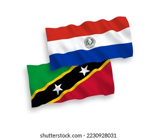 National vector fabric wave flags of Federation of Saint Christopher and Nevis and Paraguay isolated on white background. 1 to 2 proportion.