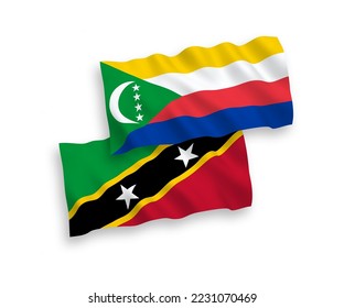 Banderas de olas de tela vectorial nacional de la Federación de Saint Christopher y Nevis y la Unión de las Comoras aisladas en fondo blanco. de 1 a 2.