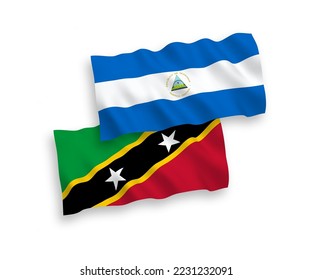 Nationale Vektor-Wellen-Flaggen der Föderation von Saint Christopher und Nevis und Nicaragua einzeln auf weißem Hintergrund. 1 bis 2 %.