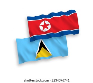 National vector fabric wave flags of North Korea and Saint Lucia isolated on white background. 1 to 2 proportion.