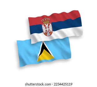 National vector fabric wave flags of Saint Lucia and Serbia isolated on white background. 1 to 2 proportion.