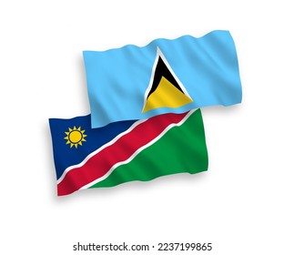 National vector fabric wave flags of Saint Lucia and Republic of Namibia isolated on white background. 1 to 2 proportion.