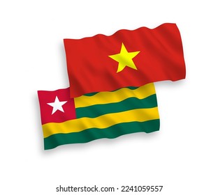 National vector fabric wave flags of Togolese Republic and Vietnam isolated on white background. 1 to 2 proportion.
