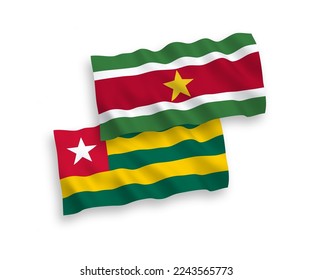 National vector fabric wave flags of Togolese Republic and Republic of Suriname isolated on white background. 1 to 2 proportion.