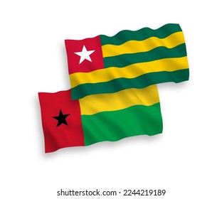 National vector fabric wave flags of Togolese Republic and Republic of Guinea Bissau isolated on white background. 1 to 2 proportion.