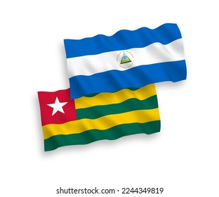 National vector fabric wave flags of Togolese Republic and Nicaragua isolated on white background. 1 to 2 proportion.