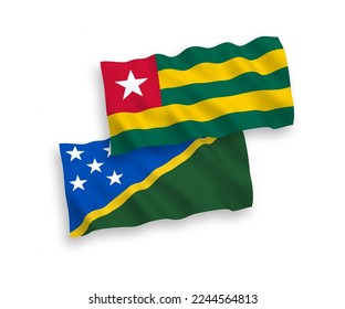 National vector fabric wave flags of Togolese Republic and Solomon Islands isolated on white background. 1 to 2 proportion.