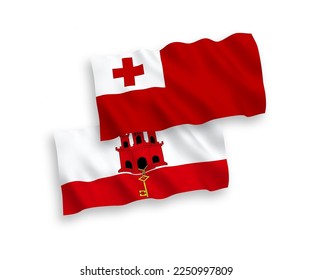 National vector fabric wave flags of Kingdom of Tonga and Gibraltar isolated on white background. 1 to 2 proportion.