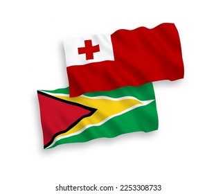 National vector fabric wave flags of Kingdom of Tonga and Co-operative Republic of Guyana isolated on white background. 1 to 2 proportion.
