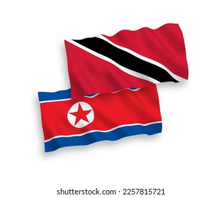 National vector fabric wave flags of North Korea and Republic of Trinidad and Tobago isolated on white background. 1 to 2 proportion.