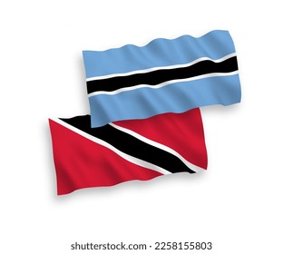 National vector fabric wave flags of Republic of Trinidad and Tobago and Botswana isolated on white background. 1 to 2 proportion.