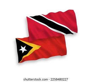 National vector fabric wave flags of Republic of Trinidad and Tobago and East Timor isolated on white background. 1 to 2 proportion.