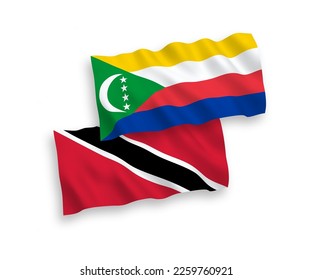 National vector fabric wave flags of Republic of Trinidad and Tobago and Union of the Comoros isolated on white background. 1 to 2 proportion.