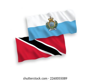 National vector fabric wave flags of Republic of Trinidad and Tobago and San Marino isolated on white background. 1 to 2 proportion.