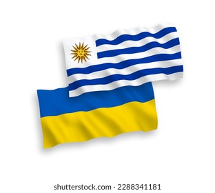 Banderas de olas de tela vectorial nacional de la República Oriental del Uruguay y Ucrania aisladas en fondo blanco. de 1 a 2.