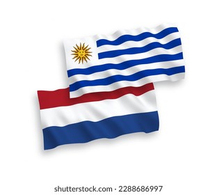 National vector fabric wave flags of Oriental Republic of Uruguay and Netherlands isolated on white background. 1 to 2 proportion.