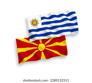 National vector fabric wave flags of Oriental Republic of Uruguay and North Macedonia isolated on white background. 1 to 2 proportion.