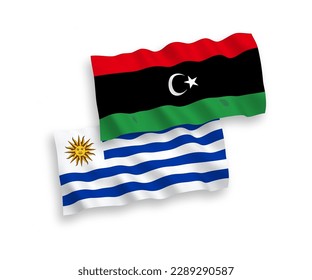 Banderas de olas de tela vectorial nacional de la República Oriental del Uruguay y Libia aisladas en fondo blanco. de 1 a 2.