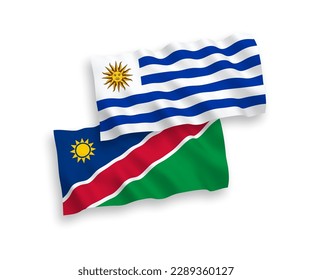 National vector fabric wave flags of Oriental Republic of Uruguay and Republic of Namibia isolated on white background. 1 to 2 proportion.