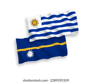 National vector fabric wave flags of Oriental Republic of Uruguay and Republic of Nauru isolated on white background. 1 to 2 proportion.