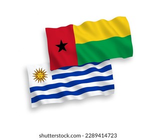 National vector fabric wave flags of Oriental Republic of Uruguay and Republic of Guinea Bissau isolated on white background. 1 to 2 proportion.