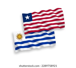 Banderas de olas de tela vectorial nacional de la República Oriental del Uruguay y Liberia aisladas en fondo blanco. de 1 a 2.