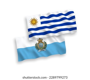 National vector fabric wave flags of Oriental Republic of Uruguay and San Marino isolated on white background. 1 to 2 proportion.