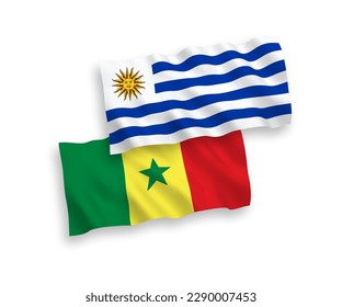 National vector fabric wave flags of Oriental Republic of Uruguay and Republic of Senegal isolated on white background. 1 to 2 proportion.