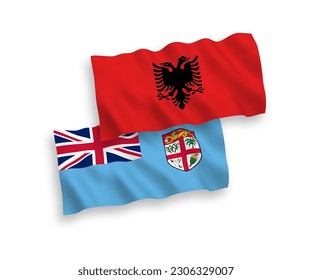 National vector fabric wave flags of Republic of Fiji and Albania isolated on white background. 1 to 2 proportion.