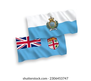 National vector fabric wave flags of Republic of Fiji and San Marino isolated on white background. 1 to 2 proportion.