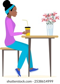 Nations and races. African American woman sitting at the table with a glass of coffee. Modern young fashionable woman with dark skin.
