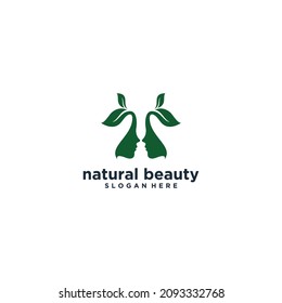 natural beauty logo with two beautiful female faces with leaf hair