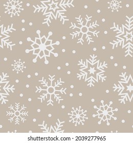 Natural beige snowflake seamless vector pattern. Neutral light coloured background with white festive snowflakes. Subtle minimal seasonal christmas holiday design. Repeating wallpaper texture print. 