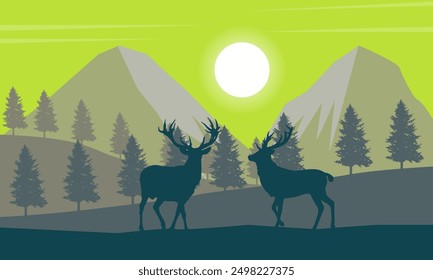 Natural landscape of mountains with the sun shining on the silhouettes of trees and wild deer