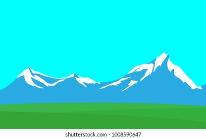 Natural panorama landscape nature view of mountain range with snow on the top peak hat with green grass field in the foreground with some copy space for your text