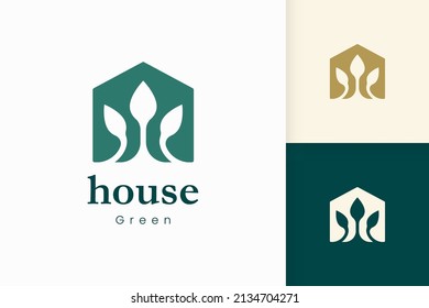 Nature green house logo with tree and leaf shape