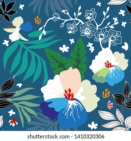 Nature inspired seamless pattern. Floral print with large tropical flowers and palm leaves on blue background. Summer textile collection.