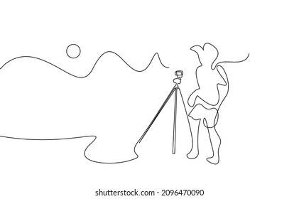 nature photographer taking pictures with camera and tripod