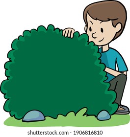 naughty boy hides behind a bush