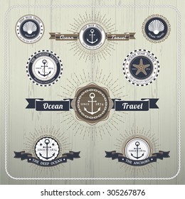 Nautical anchor travel labels with ray burst and ribbon on wood background