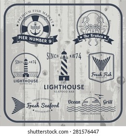 Nautical and seafood labels logo set with rope frame on gray wood background