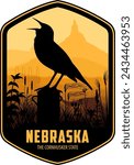 Nebraska vector label with western meadowlark and bison skull on the prairie near Chimney Rock National Historic Site